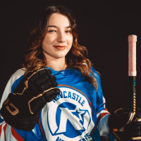 Headshot of Rochelle Manning, Sydney Sirens reporter for 6ix Dub Hockey, smiling in a Newcastle Northstars hockey jersey while wearing a glove and holding a hockey stick against a black background.